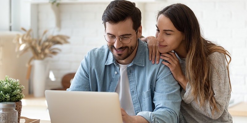 Couple using laptop to shop