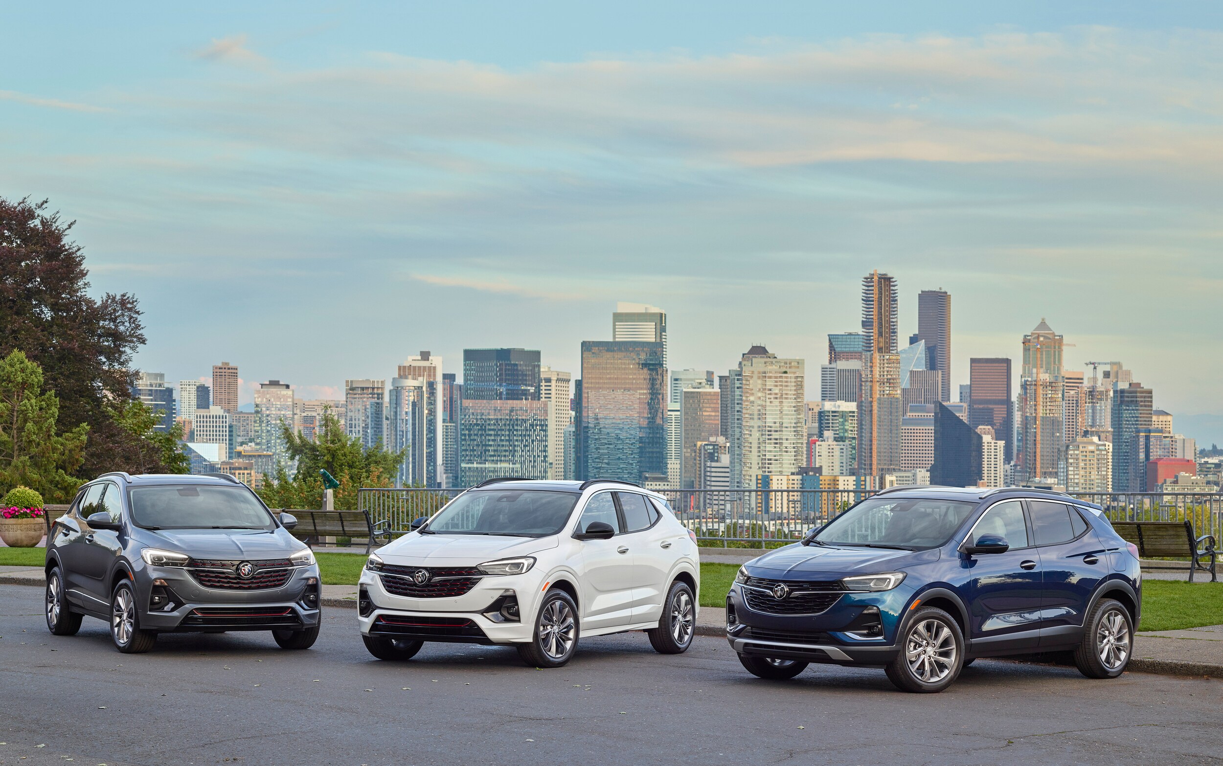 Lineup of Buick Encore SUV in front of City Skyline