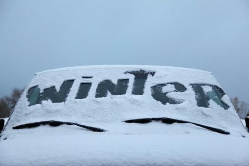 Photo of the word Winter written in snow on a windshield