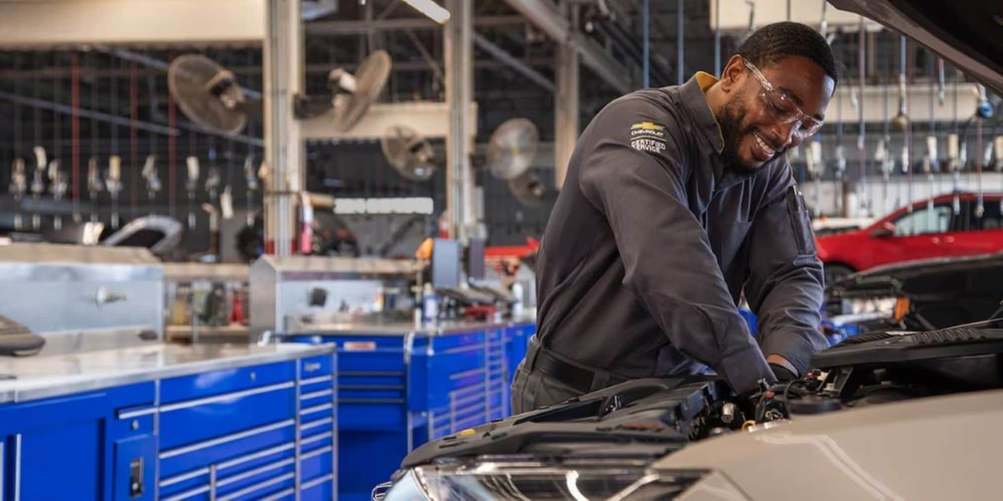 A mechanic working on a Chevy Vehicle