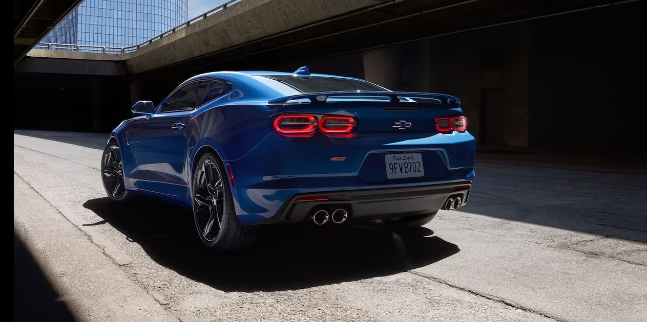 A view of the back of a blue 2023 Chevy Camaro parked in an alley