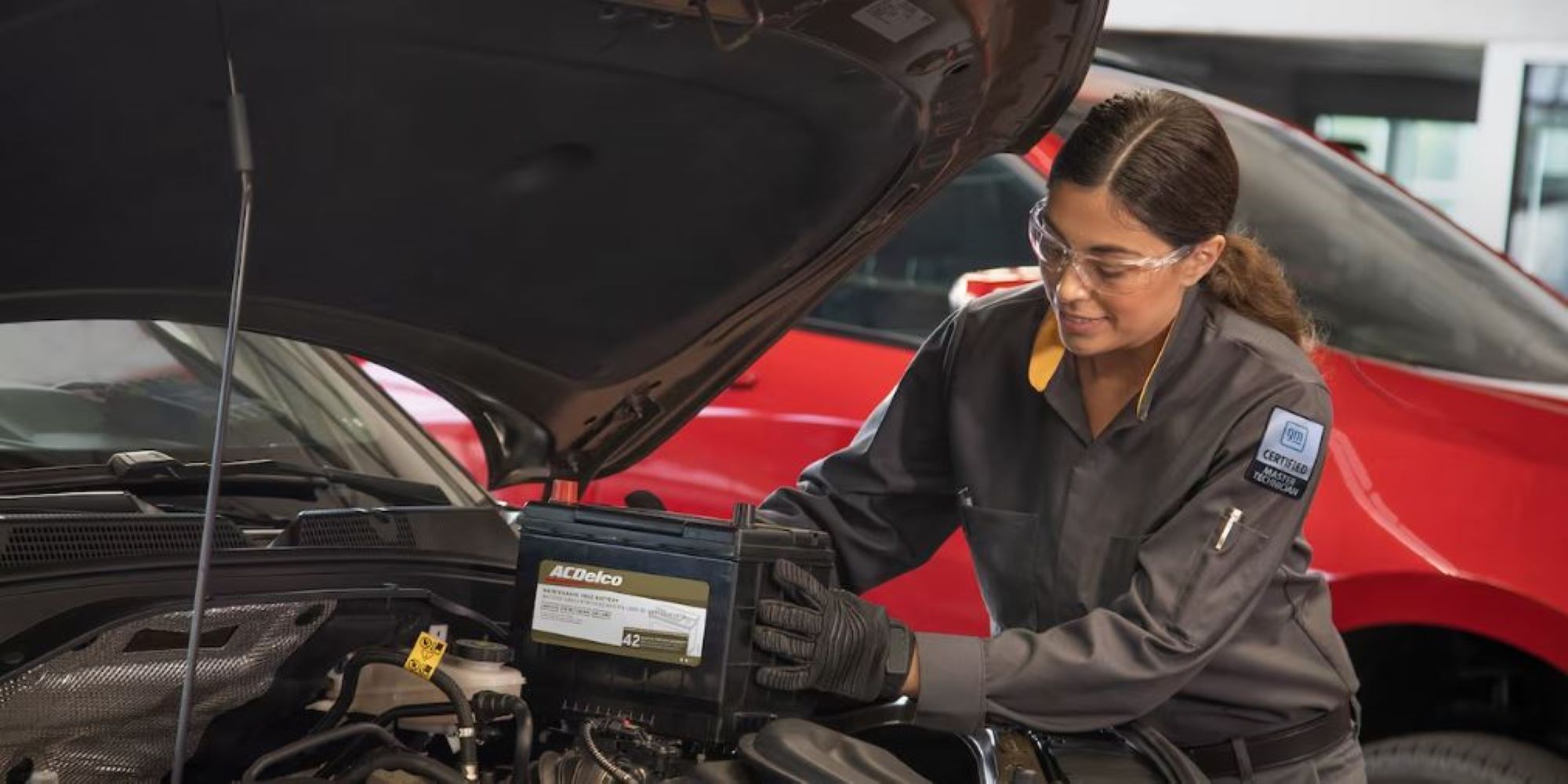 A mechanic installing a new car battery.