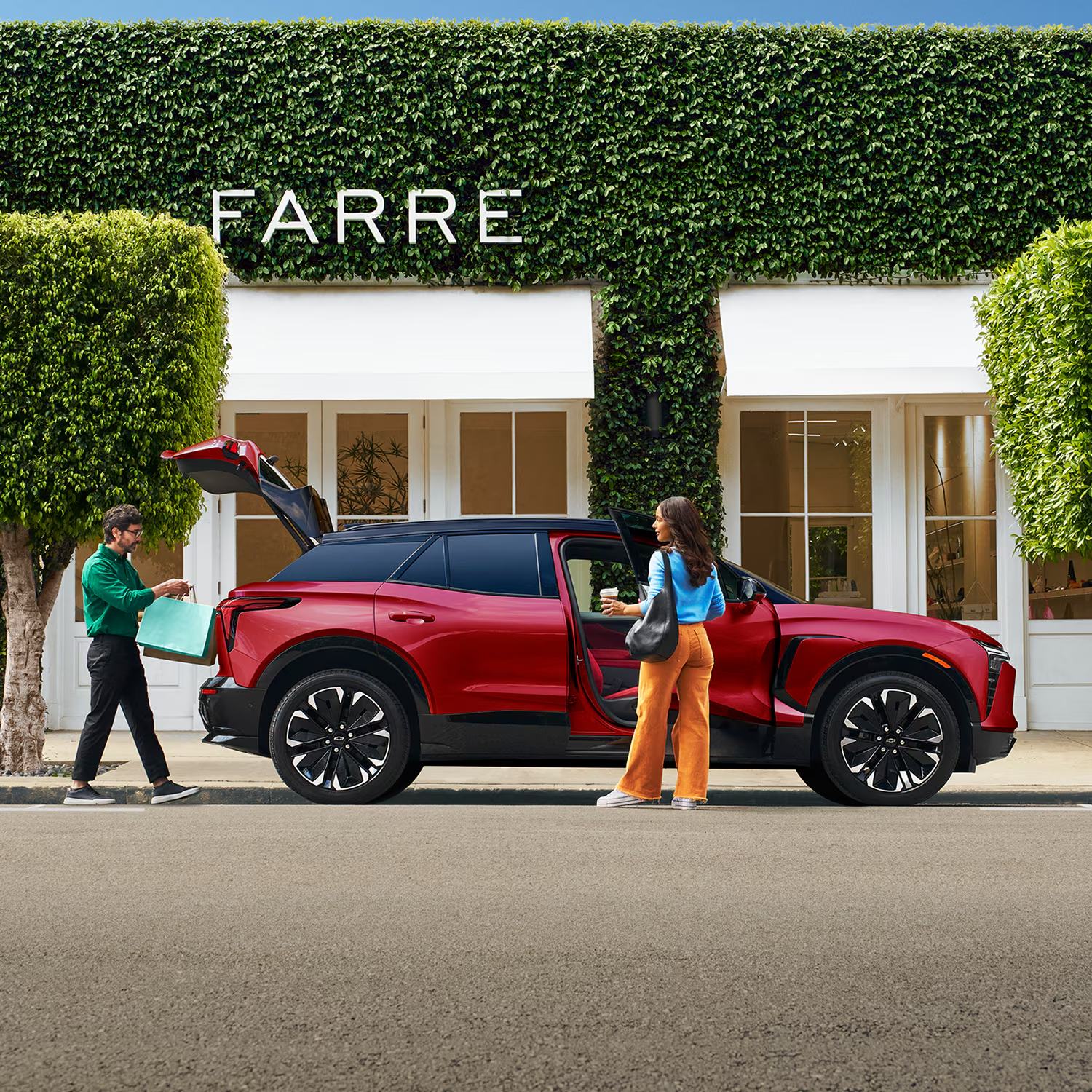 Red Chevy Blazer EV parked outside a shop with the liftgate and rear door open
