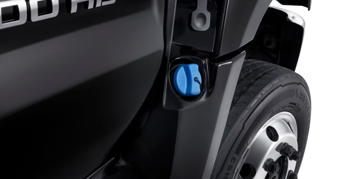 Close-up of a Chevy Silverado 4500HD 19.5-inch front wheel and fill cap behind the HD badge