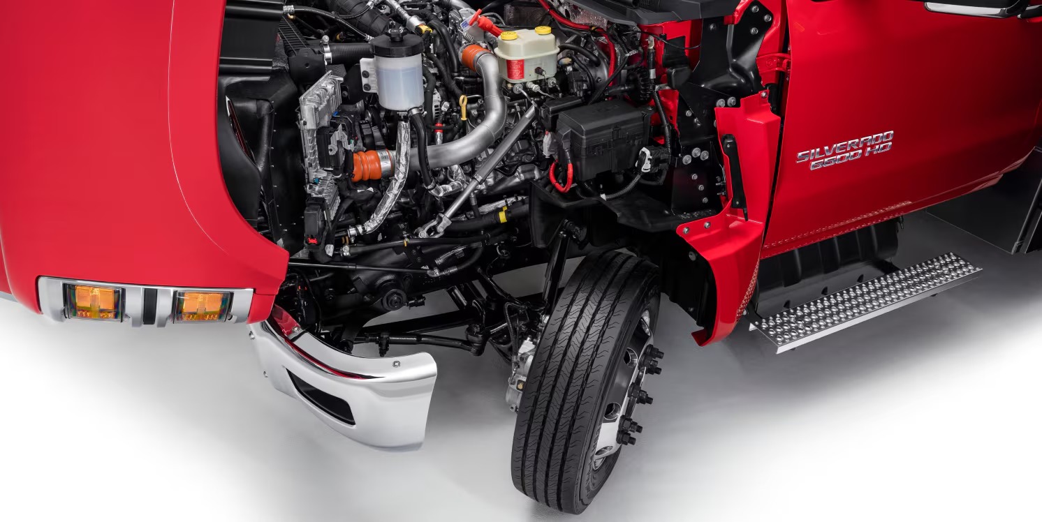 Chevy Silverado 4500HD with its tilting hood open, showing the Duramax engine and front wheel turned