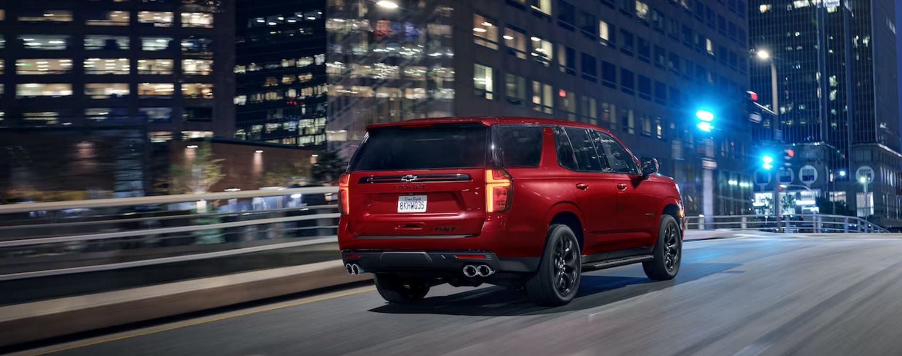 A Chevy Tahoe driving through a city street.