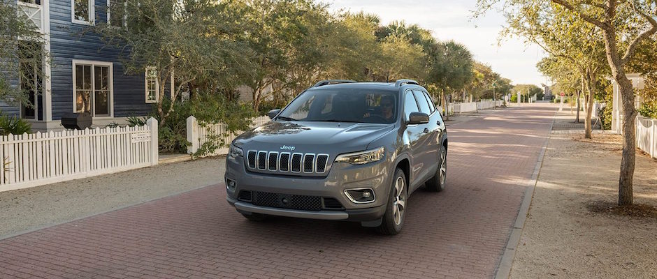 Best Family SUVs A Jeep SUV driving through a neighborhood