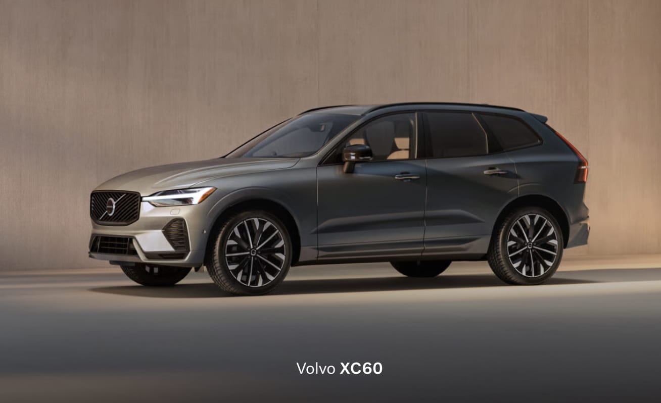 Sleek Volvo 2026 XC60 parked in a well-lit garage, highlighting its metallic gray finish, distinctive grille, and stylish alloy wheels.
