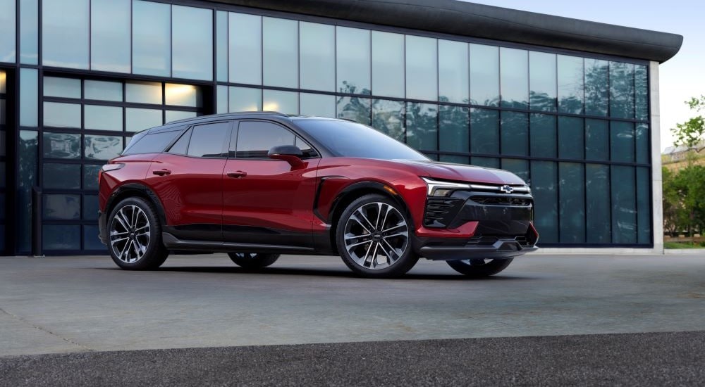 A red 2024 Chevy Blazer EV is shown parked near a Chevy dealer near Bexley.