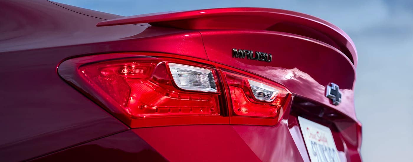 A close up shows the spoiler on a red 2023 Chevy Malibu.