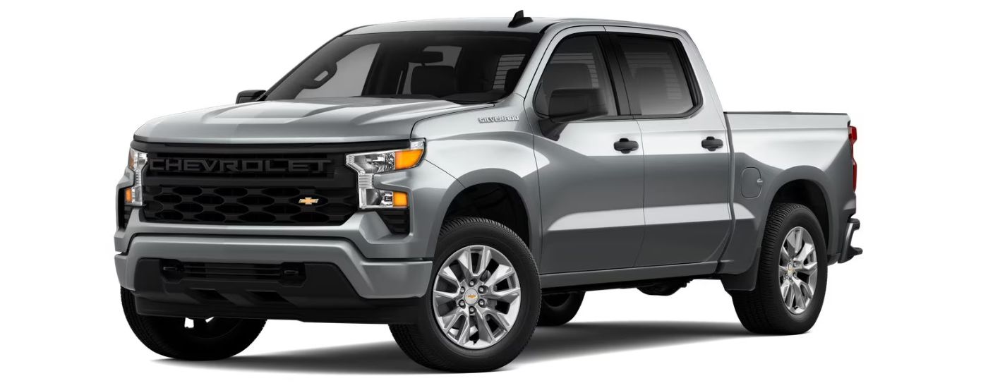 A silver 2023 Chevy Silverado 1500 Custom is angled left.