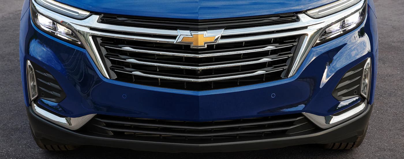A close up of the grille on a blue 2022 Chevy Equinox Premier is shown.