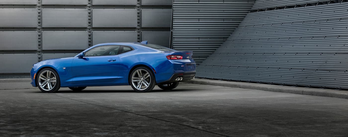 A blue 2016 Chevy Camaro RS is shown parked on concrete.