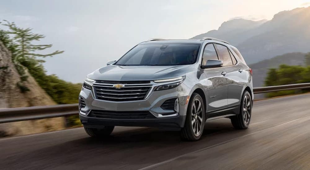 A silver 2024 Chevy Silverado is shown driving on a highway after visiting a Pataskala Chevy dealer.