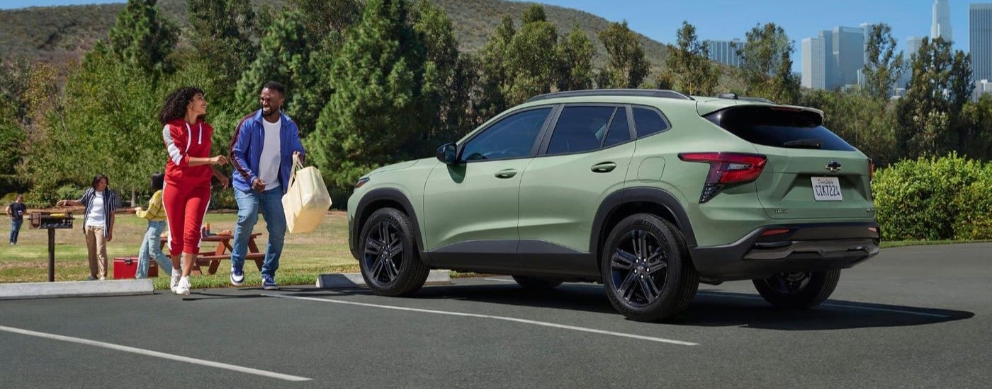 A green 2024 Chevy Trax Activ is shown near a cookout.
