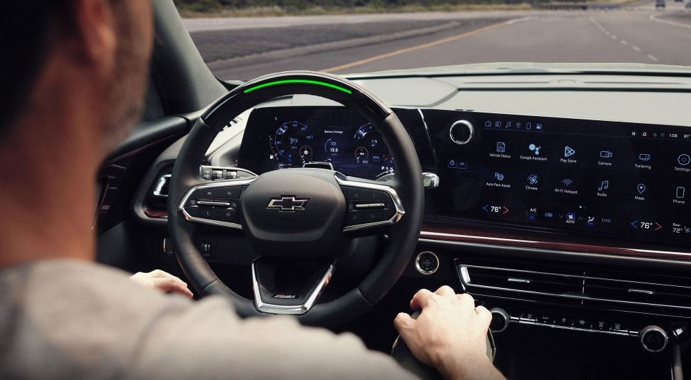 A person is shown using the Super Cruise feature in a 2024 Chevy Traverse Z71.