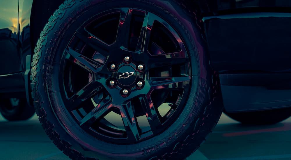 A close up shows the black rim on a 2023 Chevy Silverado 1500.
