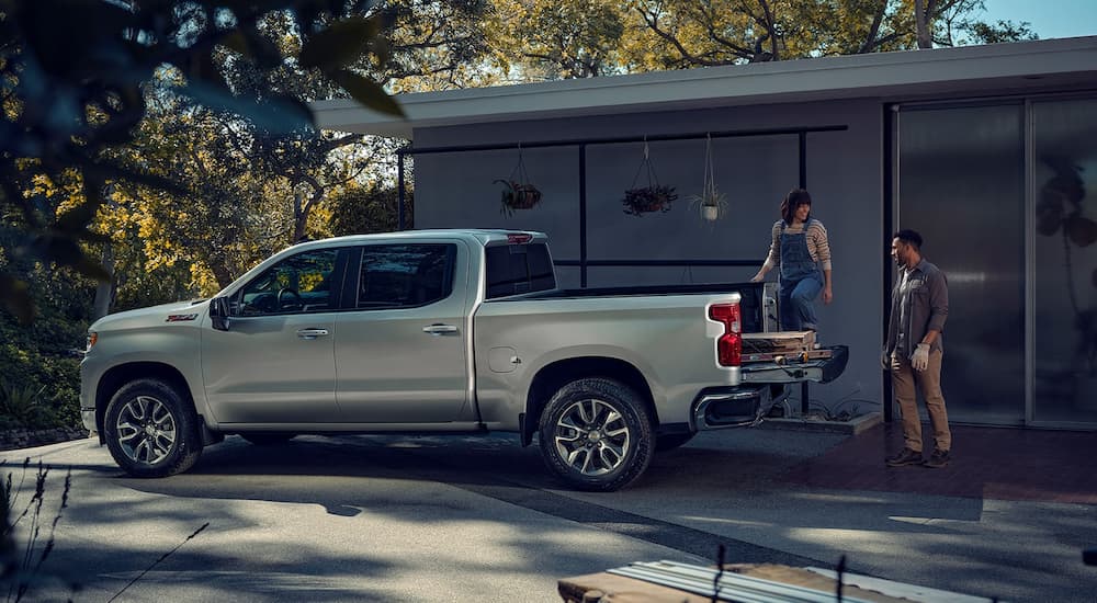 A silver 2023 Chevy Silverado 1500 Z71 is shown from the side in a driveway.