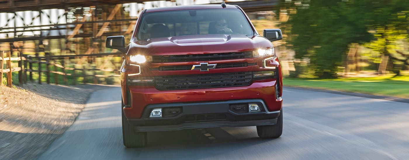 A red 2020 Chevy Silverado is shown from the front driving on road after viewing a Chevy Silverado for sale near Reynoldsburg, OH.