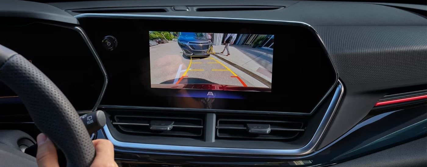 A close up shows the back up camera view on the infotainment screen in a 2024 Chevy Trax.