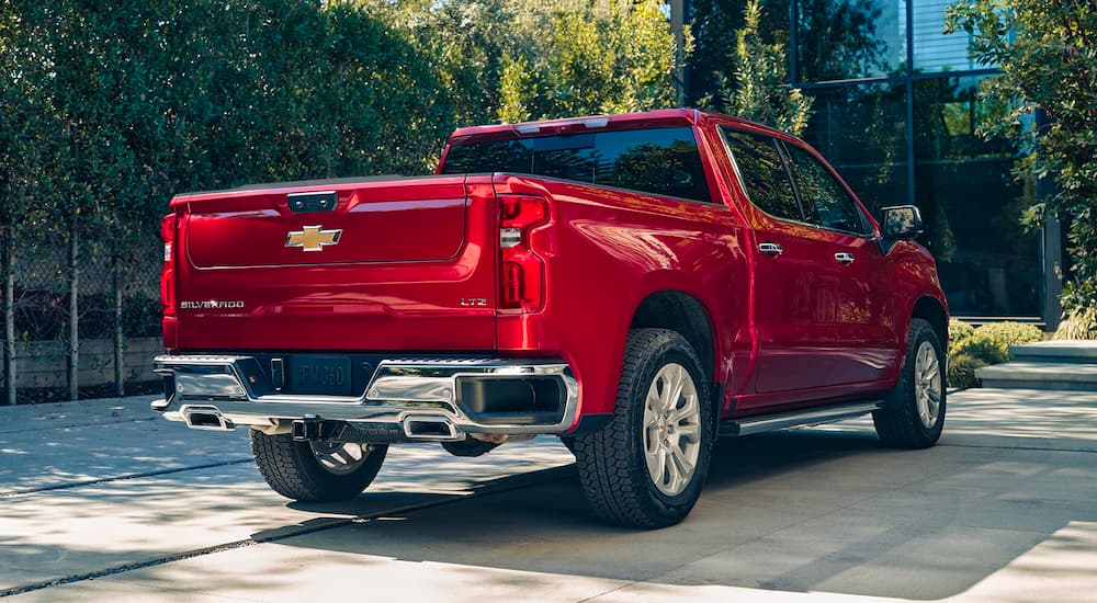 A red 2023 Chevy Silverado 1500 LTZ is shown from the rear parked in a driveway.