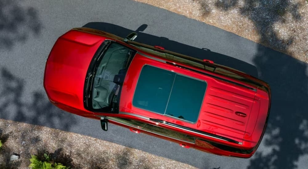A red 2024 Chevy Traverse is shown from an aerial view.