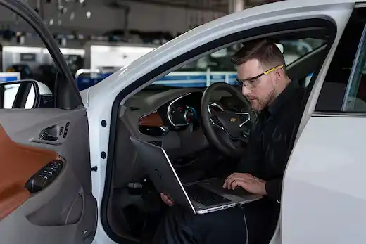 Dave Gill Chevrolet certified service technician inspecting pre-owned vehicle Columbus Ohio