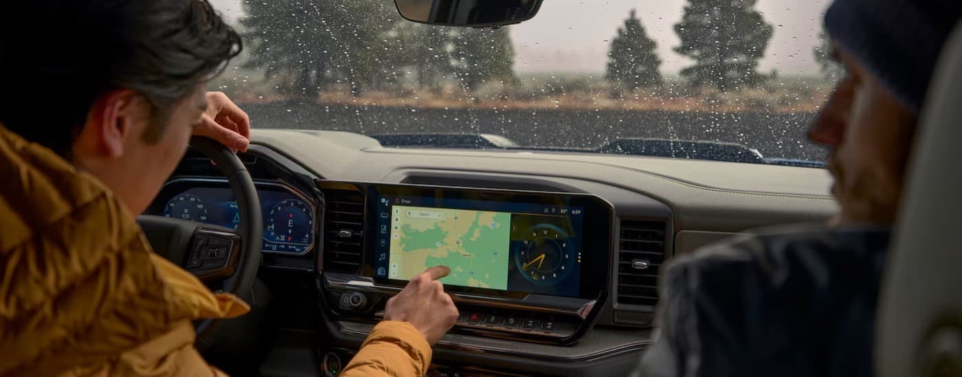 A close-up of the infotainment screen is shown in a 2025 Chevy Silverado 1500.