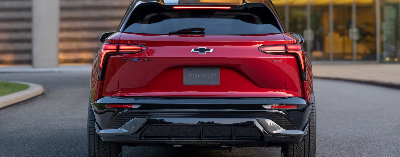 The rear of a red 2024 Chevy Blazer EV SS parked on a city street.