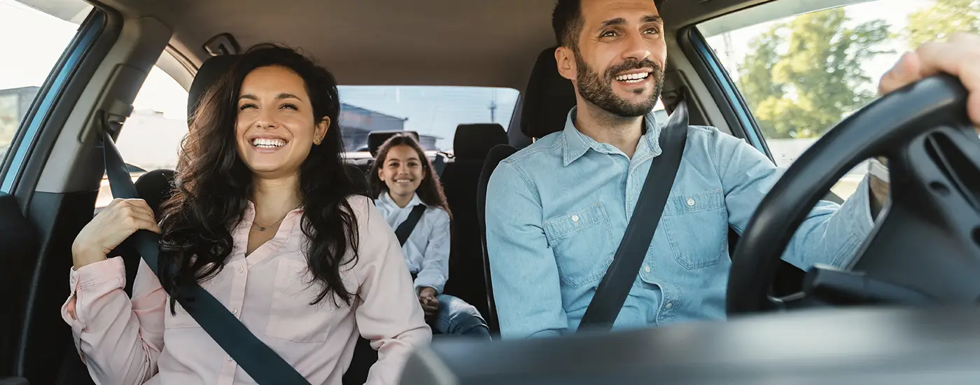 Happy family smiling inside their new Chevrolet vehicle from Dave Gill Chevrolet in Columbus, OH