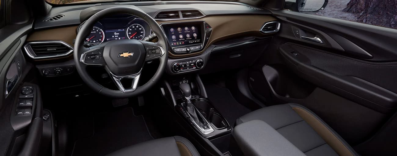 The black interior cabin and front seats of a 2021 Chevy Trailblazer for sale in Columbus.