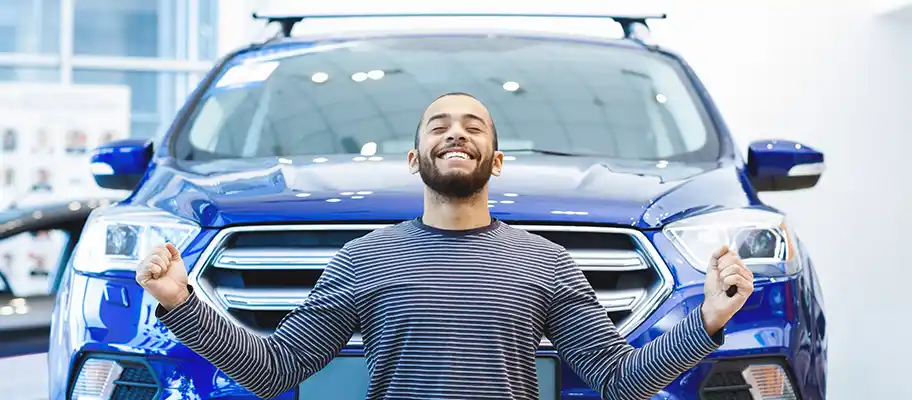 Happy man in front of a used car buy used from Dave Gill Chevy