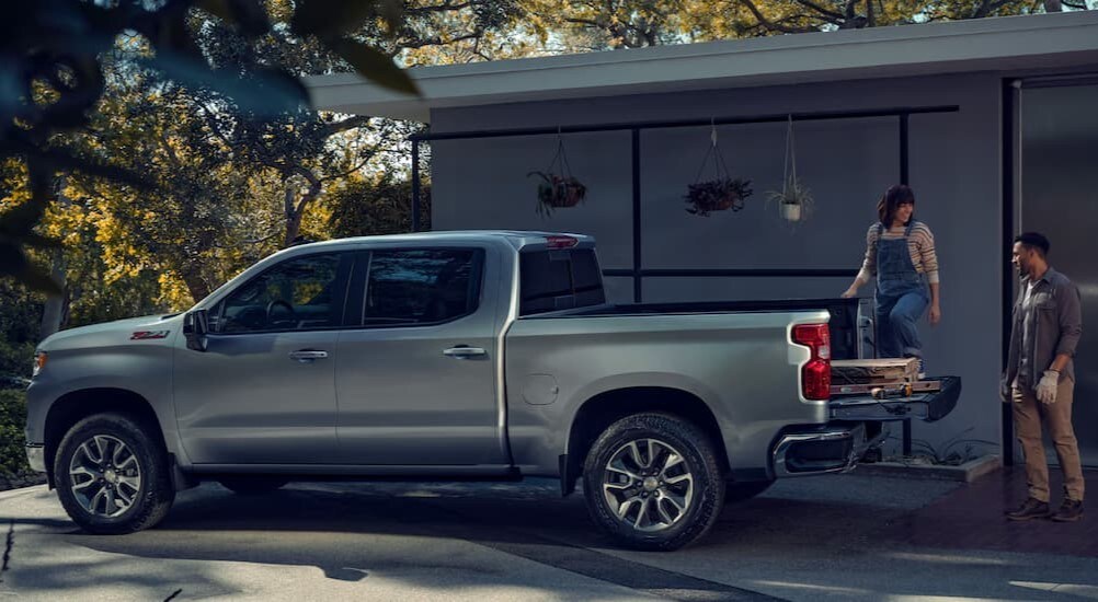 A silver 2025 Chevy Silverado 1500 Z71 is shown parked on a driveway.