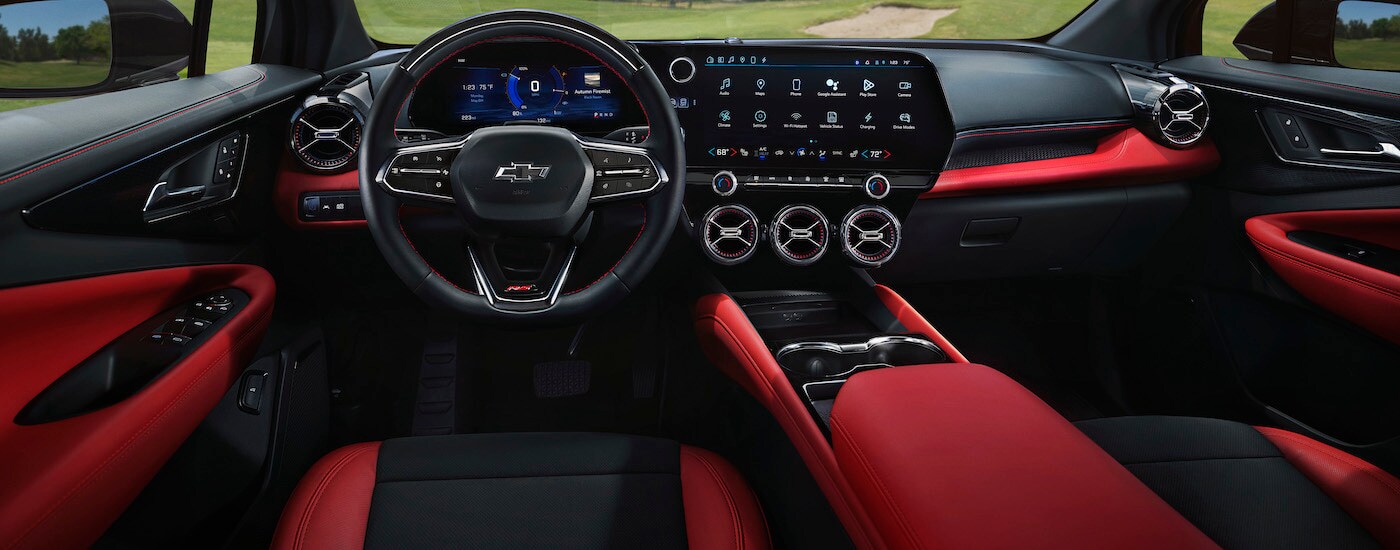 A red 2024 Chevy Blazer EV RS is shown from the driver's seat.