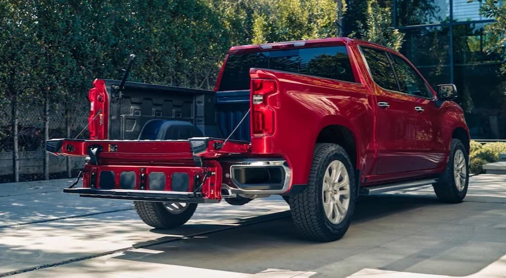 The Multi-Flex tailgate is shown open on a red 2025 Chevy Silverado 1500 for sale in Columbus.