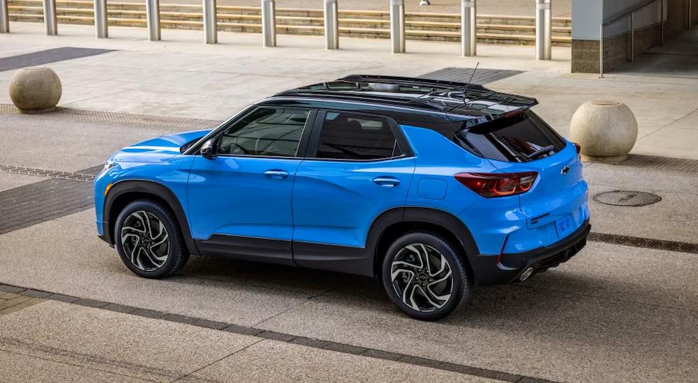 A blue 2024 Chevy Trailblazer RS is shown from a rear side angle on a city street.
