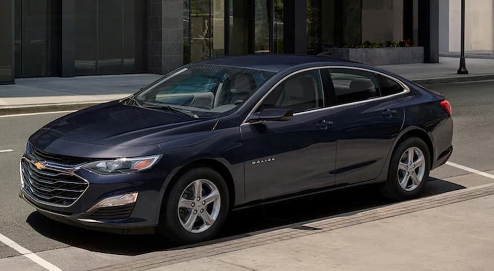  A blue 2024 Chevy Malibu is shown parked near a Chevy dealer near Canal Winchester.