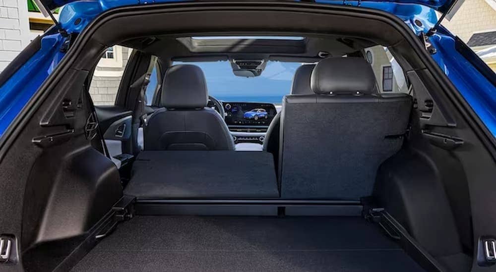  The black interior and rear cargo area of a 2024 Chevy Equinox EV is shown.