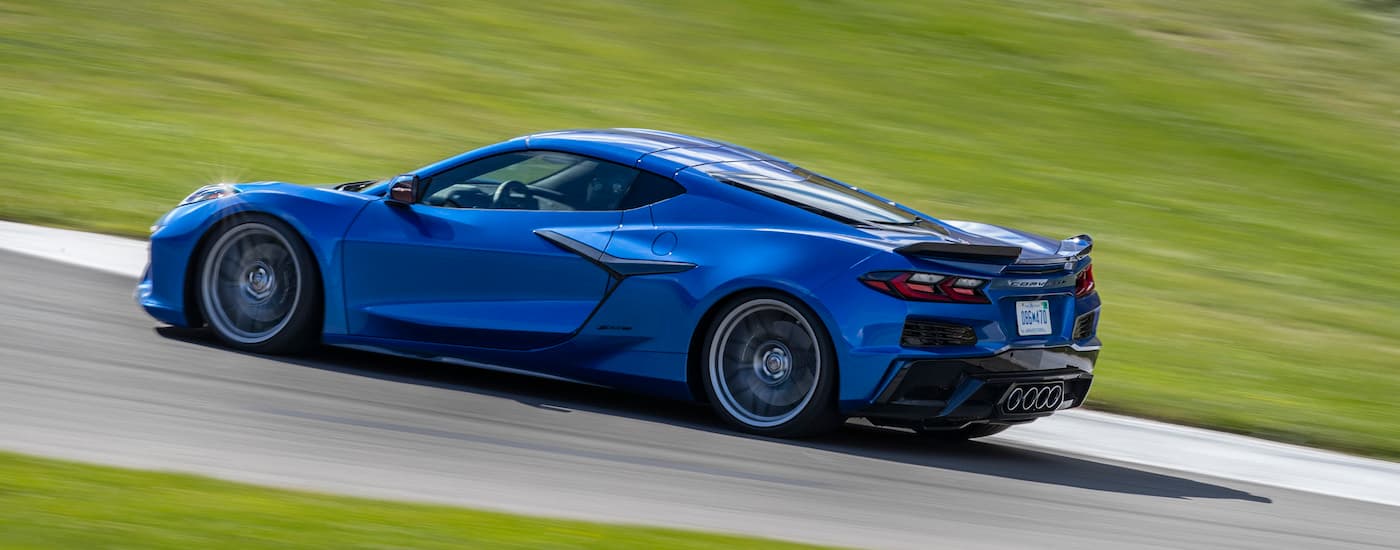 A blue 2023 Chevy Corvette Z06 is shown from the side after leaving a Chevrolet dealer.