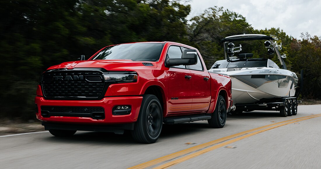  Red 2025 Ram 1500 pulling boat