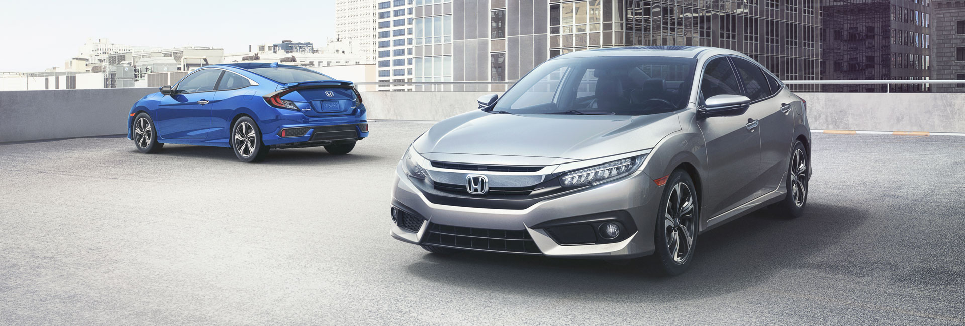 Two 2017 Honda Civic Coupes with Gray and Blue Exterior