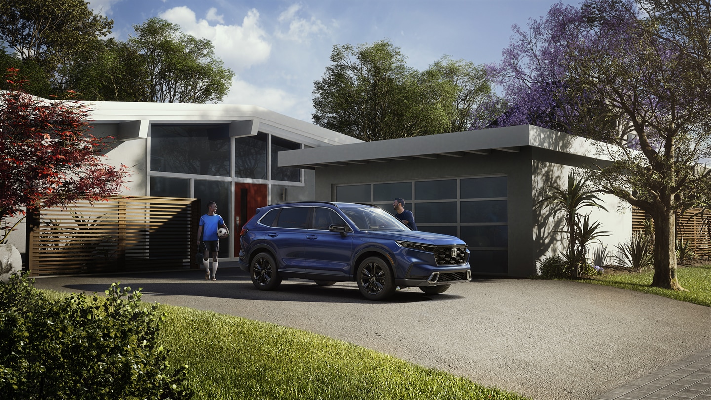 2025-Honda-CRVHybrid-Touring-SUV-L03.png Blue Honda CR-V hybrid SUV parked in a lawn