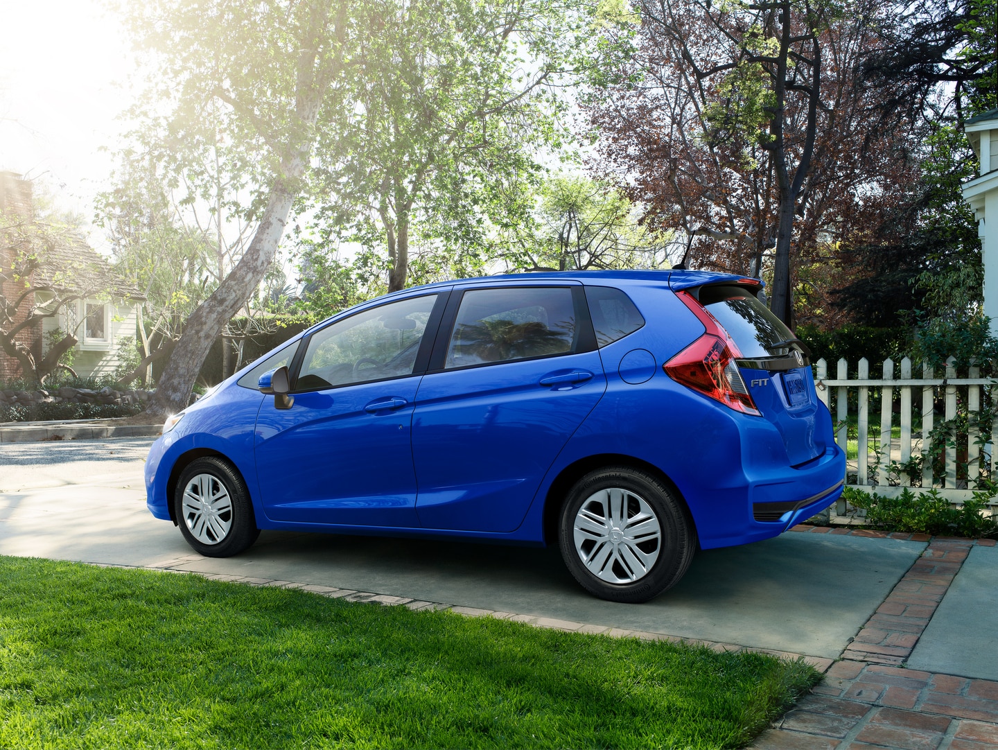 blue Honda Fit parked in a driveway