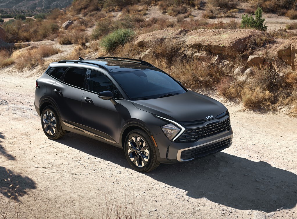 black Kia Sportage SUV parked in a desert area