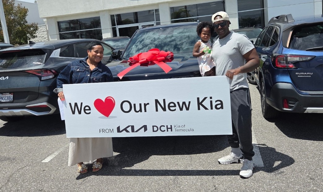 Happy family taking delivery of their new Kia at DCH Kia of Temecula
