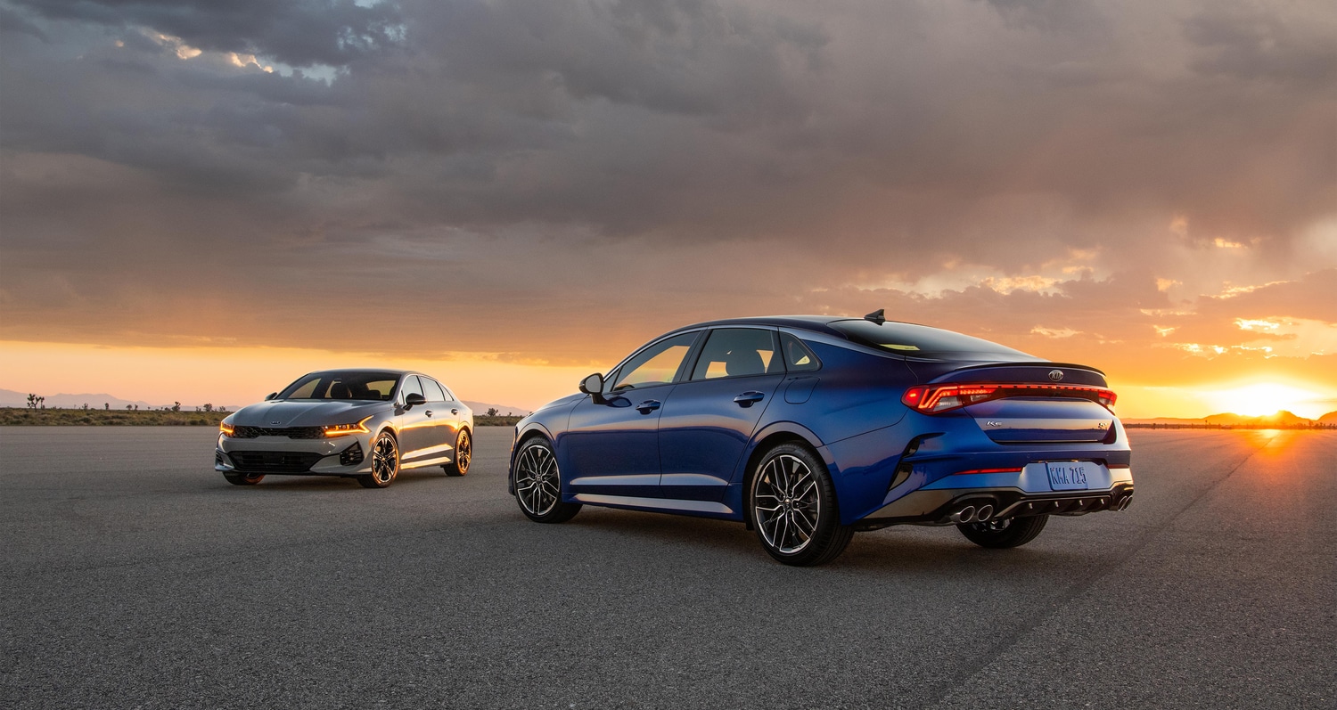 blue and grey Kia 5 parked on a tarmac