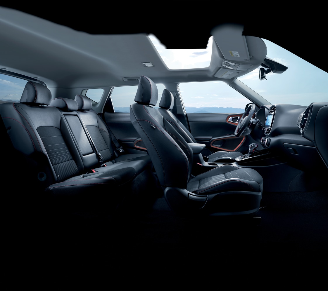 dark gray Kia Soul compact SUV interior, side view, dashboard, front and rear seats
