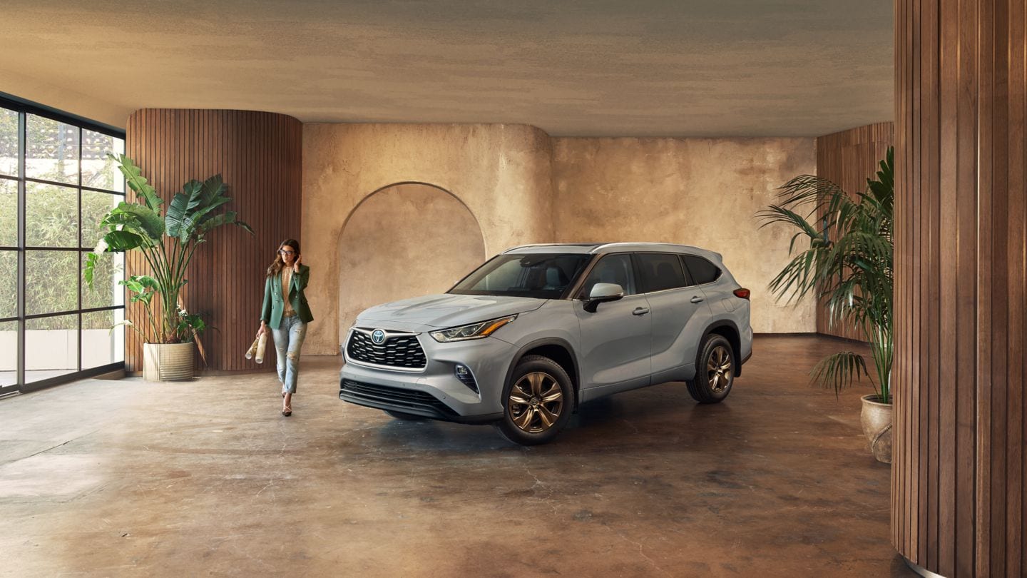 grey Toyota Highlander Hybrid parked in a marble showroom