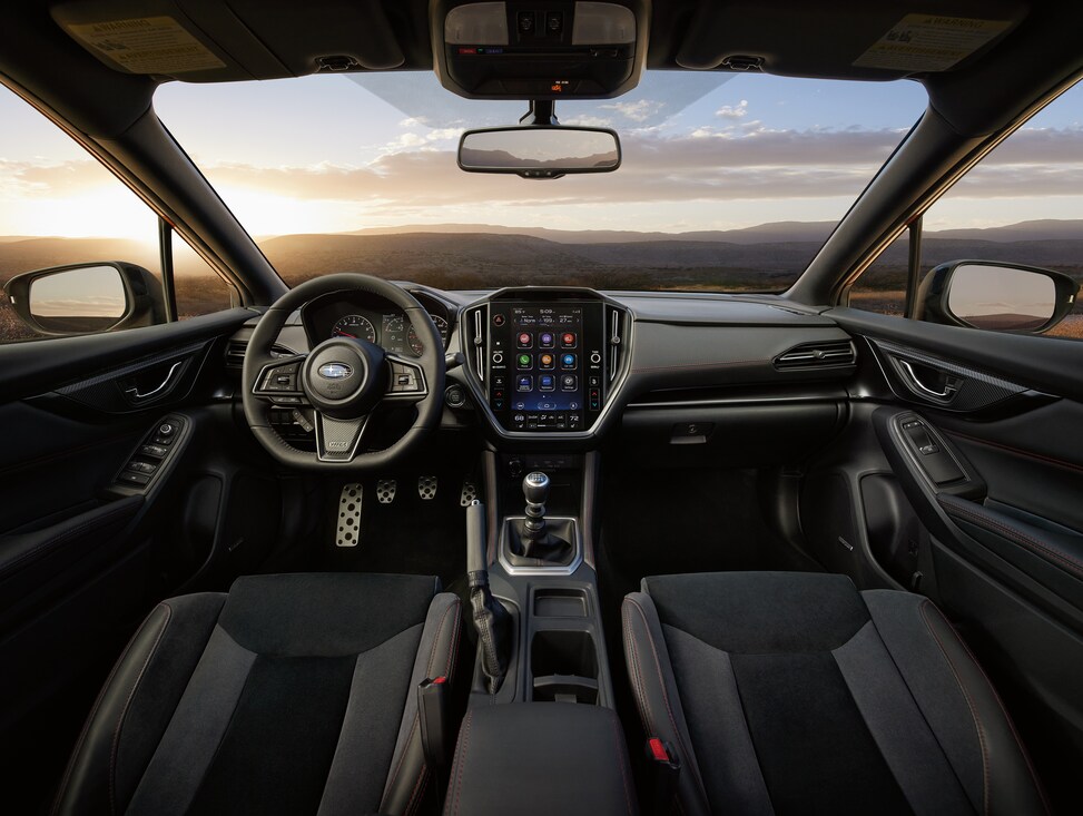 black Subaru WRX sedan interior steering wheel and dashboard area