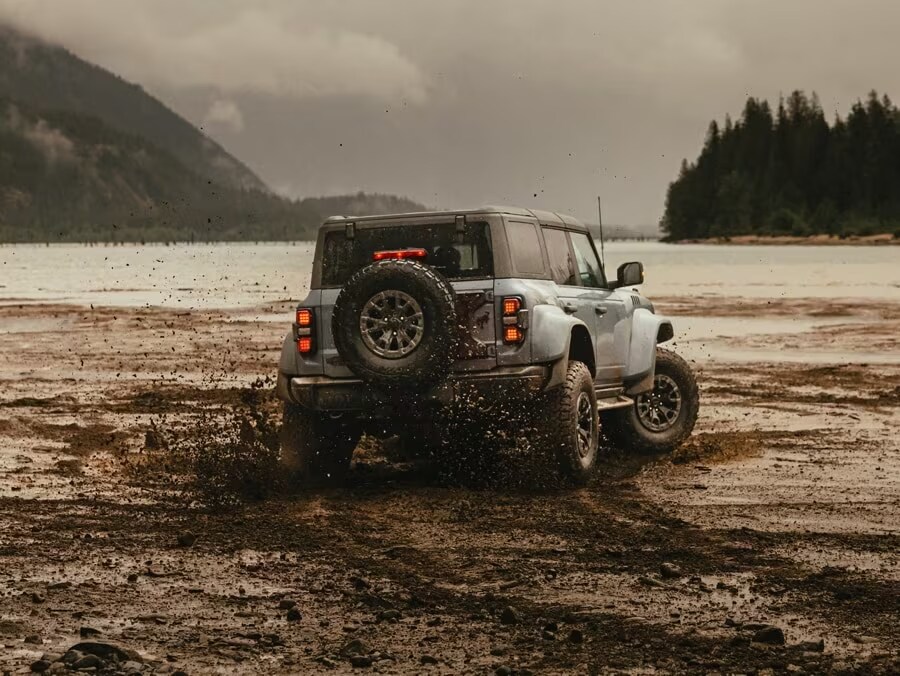 Ford Bronco driving through mud